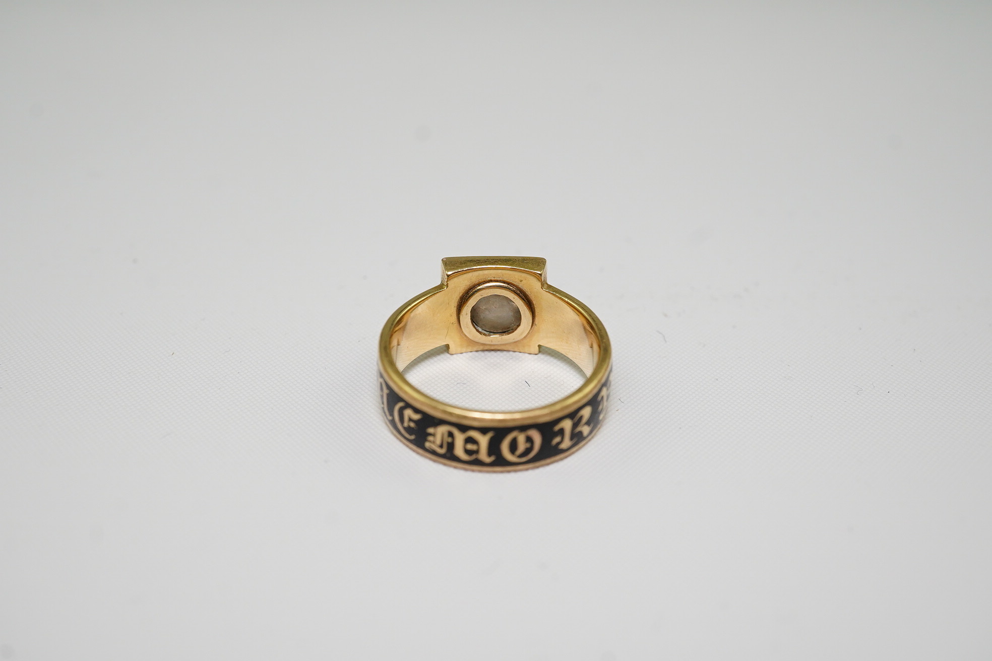 A 19th century 18ct gold, black enamel and single stone diamond set 'In Memory Of' ring